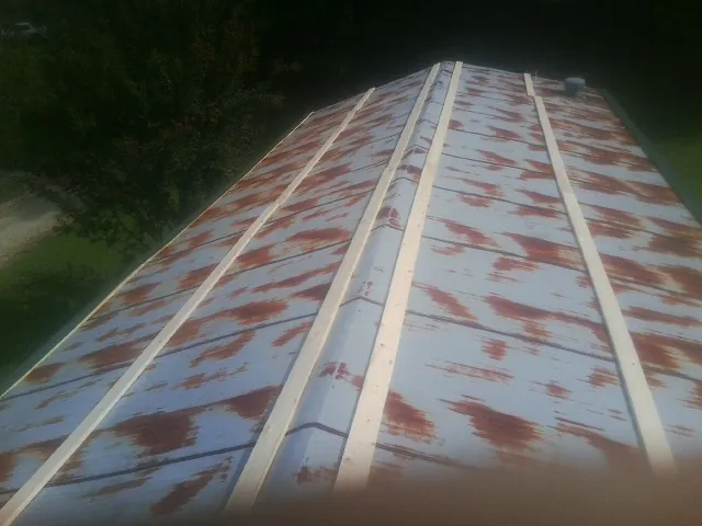 Rusted metal roof panels with new wood purlins before replacement — Storm Damage Roof Repair in Mount Perry by Roofing Brothers